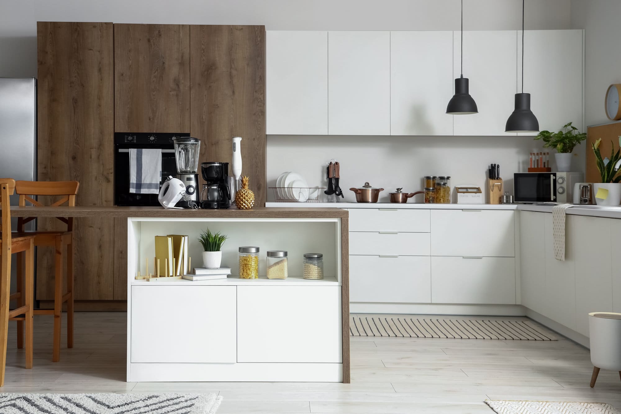 Interior of light kitchen with modern appliances on wooden table