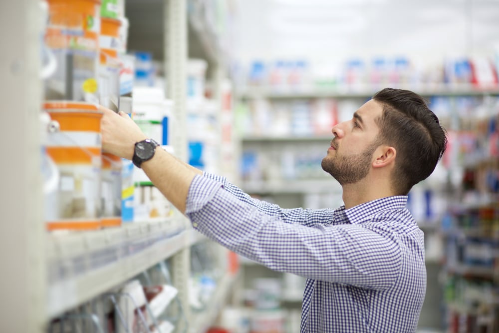 young man looking for paint for wood