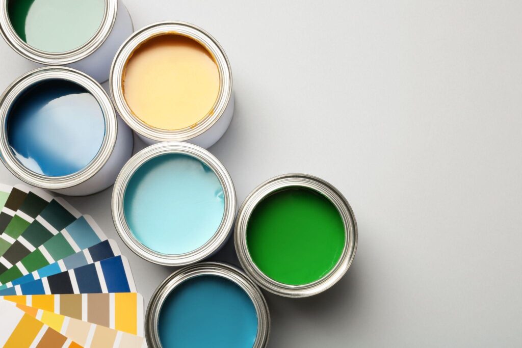 A color wheel next to open cans of paint.
